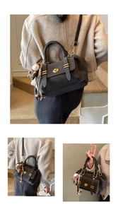 Macro shot of dark grey Boston handbag with gold hardware and plush pony charm detail
