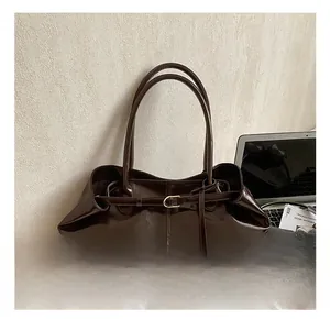 Macro view of vintage brown oil wax leather tote bag with stylish buckle and metal accents