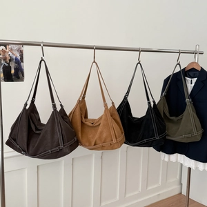 Detail of minimalist tote bags in four colors with contrast stitching and adjustable straps