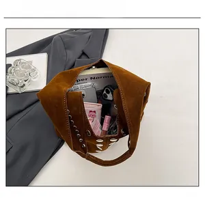 Dettaglio dell'interno di una borsa tote marrone che mostra la capacità per accessori