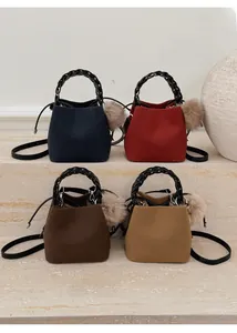 Detailed view of four felt bucket bags in navy, burgundy, coffee, and khaki on marble stairs