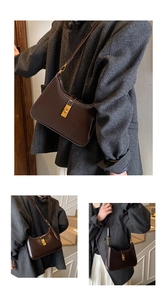 Close-up of a dark coffee shoulder bag with a polished finish and elegant gold buckle