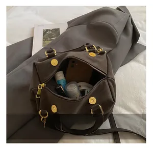 Detail view of large capacity dark brown vintage bucket bag interior with accessories