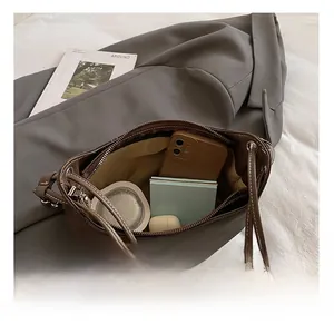 Internal view of dark brown leather crossbody bag showing spacious capacity and lining