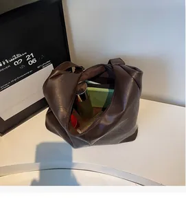 Top view of large dark brown leather tote bag showing spacious interior with zipper closure