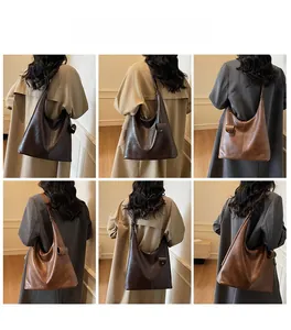 Close-up of large leather tote bag with soft texture and stylish ball pendant detail