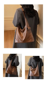 Detail view of large vintage brown hobo bag showing soft leather texture and strap accents