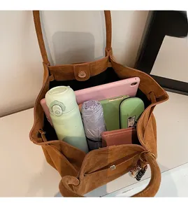 Interior view of large brown suede tote bag showing space for tablet, cup and umbrella