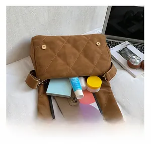 Interior view showing the large capacity of the brown quilted suede crossbody tote bag