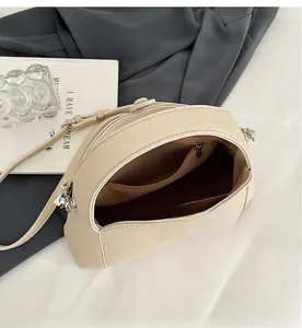 Close-up of the organized internal pockets and premium lychee texture of the shoulder bag
