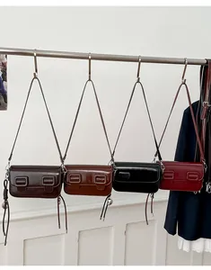 Detail van elegante crossbody tassen in koffie, karamel, zwarte en bordeaux kleuren