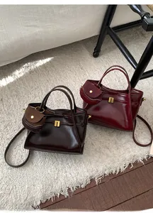 Detail of glossy vintage tote bags with metallic buckles and small charm pouches