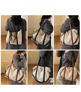 Detailansicht der vielseitigen Tragemöglichkeiten der großen Canvas-Tasche mit Kontrastgurten