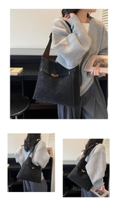 Detail of black matte tote bag with golden twist lock and wide shoulder strap
