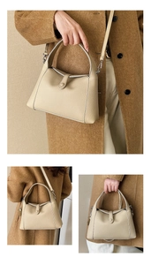 Detail shot of beige litchi grain leather bag with unique handle and buckle closure