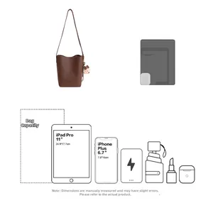 Detail view of brown leather bucket bag capacity showing fits 11 inch tablet and phone
