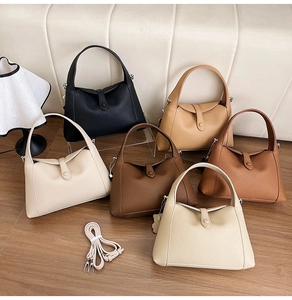 Detailed view of luxury lychee grain leather handbags in various colors with strap