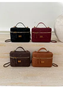Detail view of quilted leather mini bags in four colors with gold metal chain straps