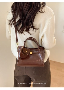 Retro deep brown tote bag with a mini pouch shown on a model in a winter outfit