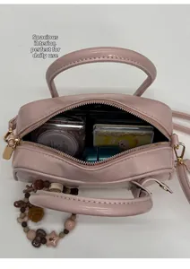Pink crossbody bag interior view showing large capacity for daily makeup and accessories
