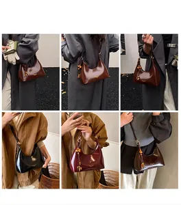 Three leather crescent bags in coffee, black and burgundy with wooden bead charms