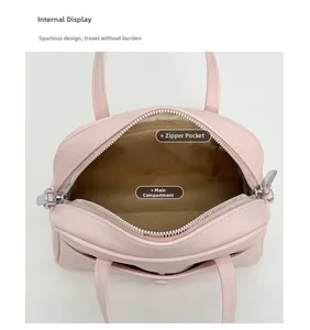 Interior view of pink leather bucket bag showing main compartment and zipper pocket