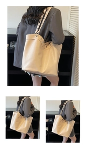 Detail view of large tote bag with silver eyelet metal decorations and leather texture