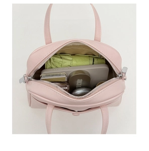 Top view of pink bucket bag showing spacious interior with umbrella and cosmetics