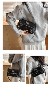 Detail of punk style underarm bag featuring silver studs and large metal buckle decor