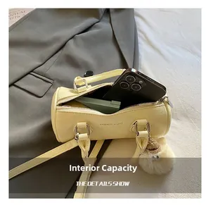 Internal capacity of yellow cylinder bag showing space for phone and card holder