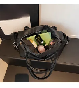 Interior view of black litchi pattern leather tote bag with large storage capacity