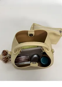 Top view of yellow bucket bag showing interior space for phone and cosmetics