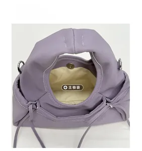 Macro view of lavender dumpling bag interior featuring magnetic closure and inner lining