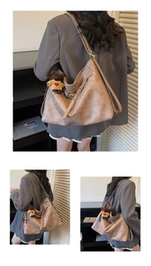 Detail view of large retro soft leather tote bag with a small bear pendant
