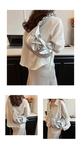 Close-up of pleated silver metallic dumpling bag with bow details and shoulder strap