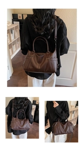 Detail showing deep brown lychee grain leather texture and adjustable strap on tote bag