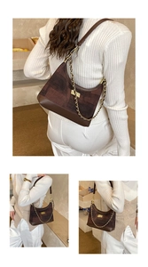 Brown patchwork hobo bag with gold chain and clasp shown on model for shoulder wear