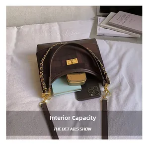 Detailed interior of vintage brown plaid bag showing spacious storage for essentials