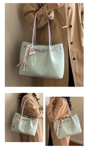 Detail of mint green glossy tote bag with purple strap and colorful tassel charm