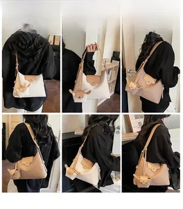 Detail view of the minimalist leather tote bag showing crossbody and shoulder strap options