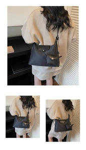 Detail of minimalist black nylon shoulder bag with a matching mini coin purse attachment