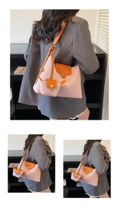 Detail of pink and orange leather shoulder bag set with mini pouch shown on model