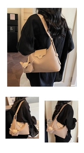 Detailed views of beige leather tote bag with a cute rabbit-shaped coin purse charm