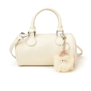 Creamy white cylindrical baguette bag in pebbled PU leather with plush charm