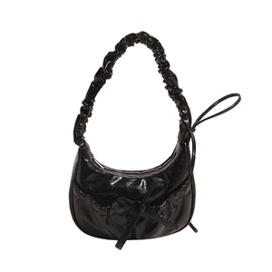 Black patent leather crescent bag with bow decoration and pleated shoulder strap