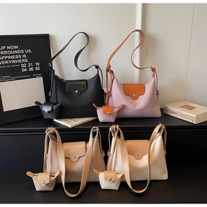 Collection of nylon shoulder bags with leather flaps in black, pink, and cream colors