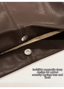 Detail of dark brown leather tote featuring a hidden magnetic clasp and secure stitching