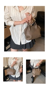 Detailed view of caramel lychee grain leather handbag with rounded handles and metal zipper