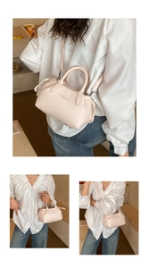 Detailed view of pink mini tote bag with litchi texture and adjustable shoulder strap
