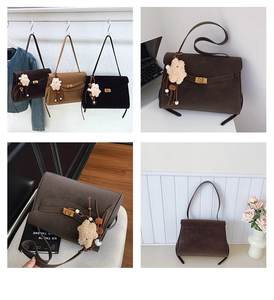Detail of vintage matte shoulder bags showing metal lock clasp and plush bear charm
